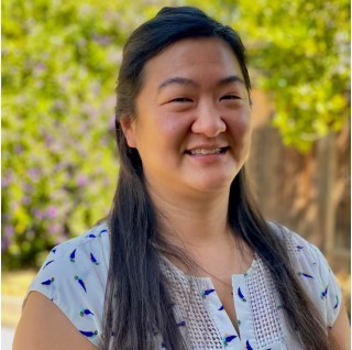 Dr. Jennifer Ree, DVM - Veterinarian at Acacia Pet Clinic smiling outdoors, showcasing commitment to pet health and well-being.